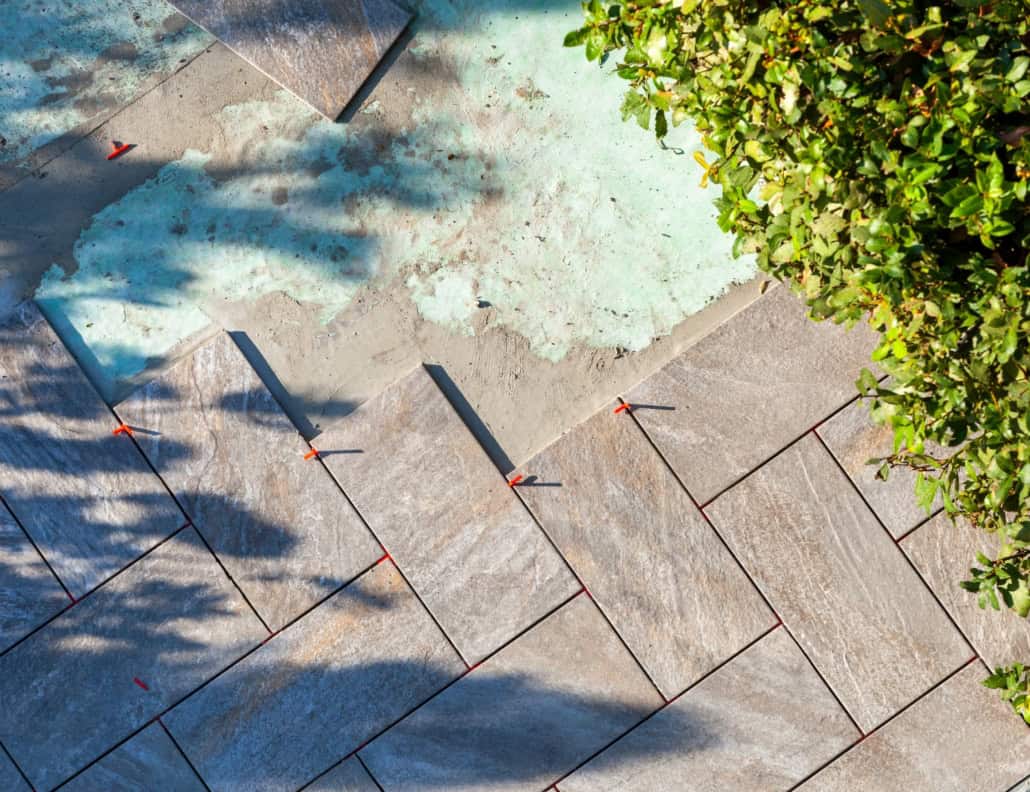 Laying outdoor pavers for a hardscape landscape design and build 